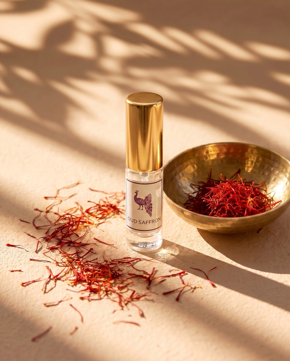 Oud Saffron eau de parfum beside a brass bowl of saffron threads in golden light